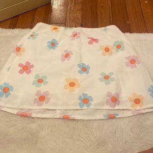 White miniskirt with multicolor pastel flowers all over.